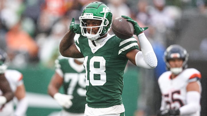 Sep 29, 2024; East Rutherford, New Jersey, USA; New York Jets wide receiver Mike Williams (18) celebrates a first down reception during the second half against the Denver Broncos at MetLife Stadium. Mandatory Credit: Vincent Carchietta-Imagn Images
