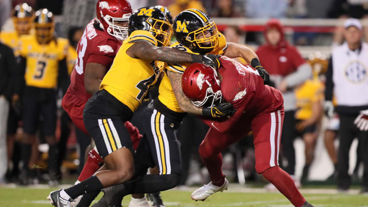Nov 24, 2023; Fayetteville, Arkansas, USA; Arkansas Razorbacks quarterback Jacolby Criswell (6) is sacked by Missouri Tigers defensive lineman Joe Moore III (45) and linebacker Chuck Hicks (30) during the second half at Donald W. Reynolds Razorback Stadium. Missouri won 48-14. Mandatory Credit: Nelson Chenault-USA TODAY Sports