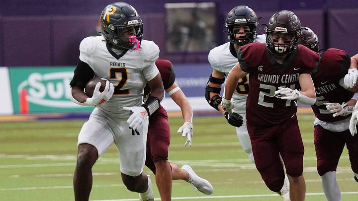 Regina's running back Savion Miller (2) runs with the ball for a first down against Grundy Center during the first quarter in the 1A High School state semi-final on Nov. 14, 2025, at UNI-Dome in Cedar Falls, Iowa. Regina's running back Savion Miller (2) runs with the ball for a first down against Grundy Center during the first quarter in the 1A High School state semi-final on Nov. 14, 2025, at UNI-Dome in Cedar Falls, Iowa.