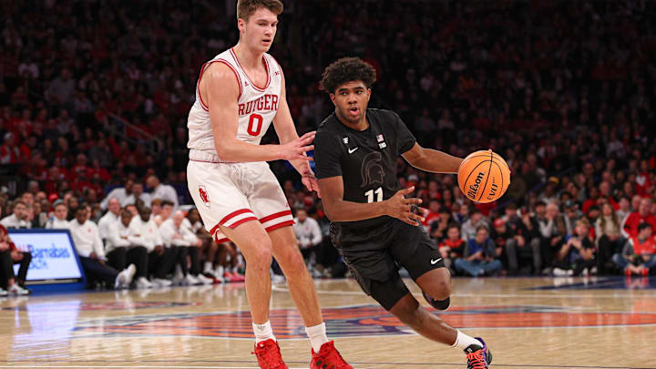 Jan 25, 2025; New York, New York, USA; Michigan State Spartans guard Jase Richardson (11) drives to the basket against Rutgers Scarlet Knights guard Jordan Derkack (0) during the second half at Madison Square Garden. Mandatory Credit: Vincent Carchietta-Imagn Images