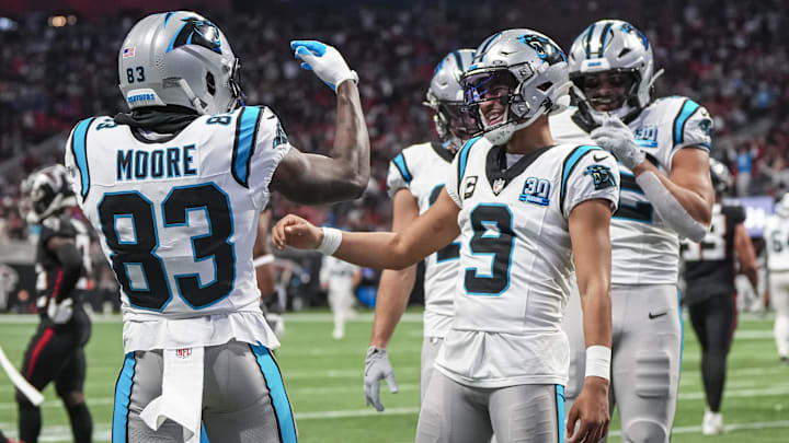 Jan 5, 2025; Atlanta, Georgia, USA; Carolina Panthers quarterback Bryce Young (9) reacts with wide receiver David Moore (83) after running for a touchdown against the Atlanta Falcons during the second half at Mercedes-Benz Stadium.