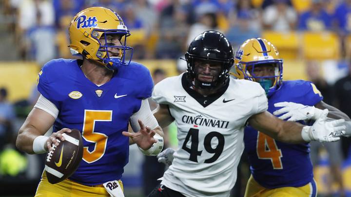 Sep 9, 2023; Pittsburgh, Pennsylvania, USA; Pittsburgh Panthers quarterback Phil Jurkovec (5) scrambles with the ball as Cincinnati Bearcats linebacker Jack Dingle (49) chases during the second quarter at Acrisure Stadium. Mandatory Credit: Charles LeClaire-Imagn Images