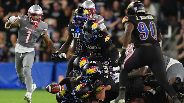 Kansas players stumble over each other for a loose ball as the Jayhawks fall to UNLV.