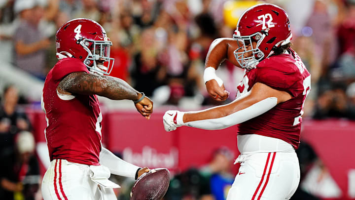 Sep 28, 2024; Tuscaloosa, Alabama, USA; Alabama Crimson Tide quarterback Jalen Milroe (4) celebrates with offensive lineman Parker Brailsford (72) after scoring a touchdown during the first quarter against the Georgia Bulldogs at Bryant-Denny Stadium. Mandatory Credit: John David Mercer-Imagn Images