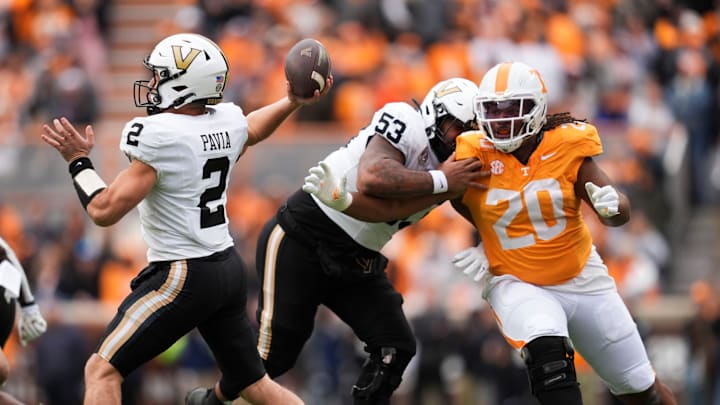 Vanderbilt quarterback Diego Pavia (2) pulls back for the throw as offensive lineman Jordan White (53) tries to hold back Tennessee defensive lineman Bryson Eason (20) in an NCAA college football game on Nov. 29, 2025, in Knoxville, Tennessee.