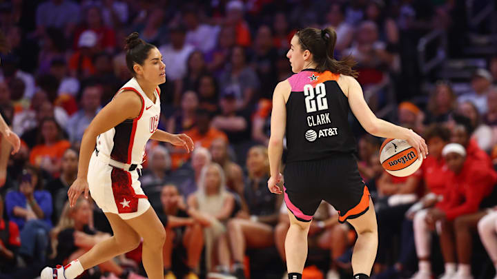 Jul 20, 2024; Phoenix, AZ, USA; Team WNBA guard Caitlin Clark (22) against USA Women's National Team player Kelsey Plum (5) at Footprint Center. Mandatory Credit: Mark J. Rebilas-Imagn Images