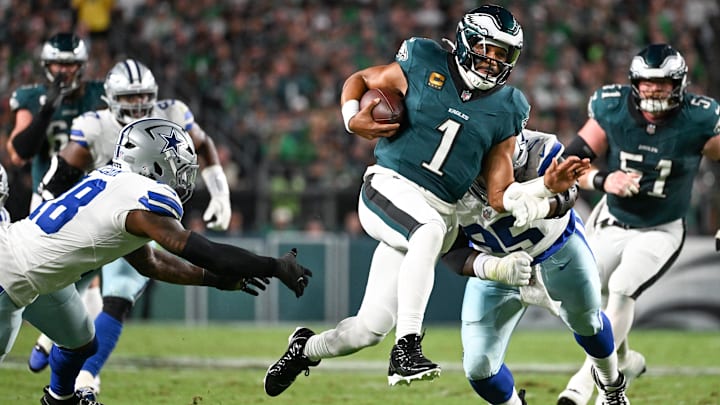 Sep 4, 2025; Philadelphia, Pennsylvania, USA; Philadelphia Eagles quarterback Jalen Hurts (1) avoids a tackle by Dallas Cowboys defensive tackle Kenny Clark (95) during the second quarter of the game at Lincoln Financial Field. Mandatory Credit: Eric Hartline-Imagn Images