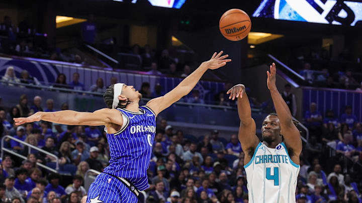 Charlotte Hornets guard Sion James (4) shoots against Orlando Magic guard Anthony Black (0) during the second half