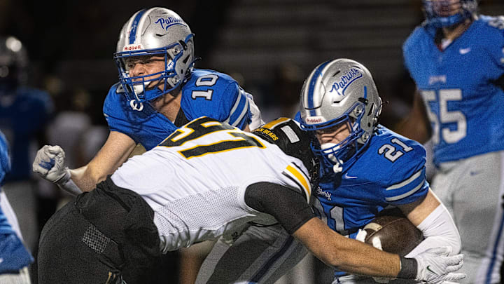 Upper Arlington’s Cal Thrush makes contact with Olentangy Liberty’s Jake Struck in a Division I, Region 3 semifinal Nov. 15, 2024, at Westerville Central. (photo by John Hulkenberg)