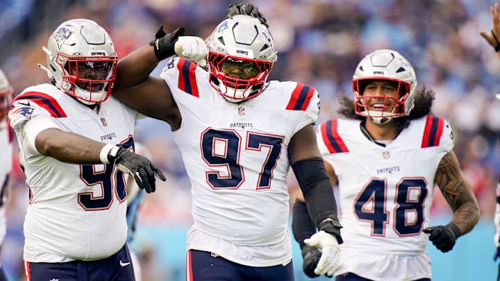 New England Patriots defensive end Milton Williams (97) celebrates sacking Tennessee Titans quarterback Cam Ward (1) during the third quarter at Nissan Stadium in Nashville, Tenn., Sunday, Oct. 19, 2025.