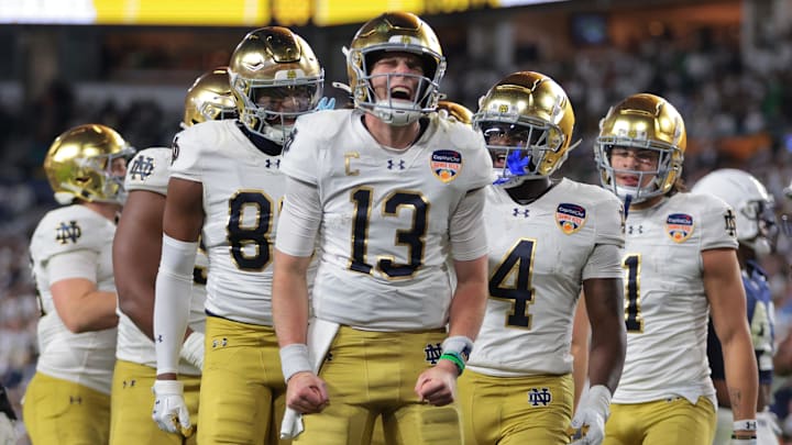 Jan 9, 2025; Miami, FL, USA; Notre Dame Fighting Irish quarterback Riley Leonard (13) celebrates a touch down with teammates in the second half against the Penn State Nittany Lions  in the Orange Bowl at Hard Rock Stadium. 