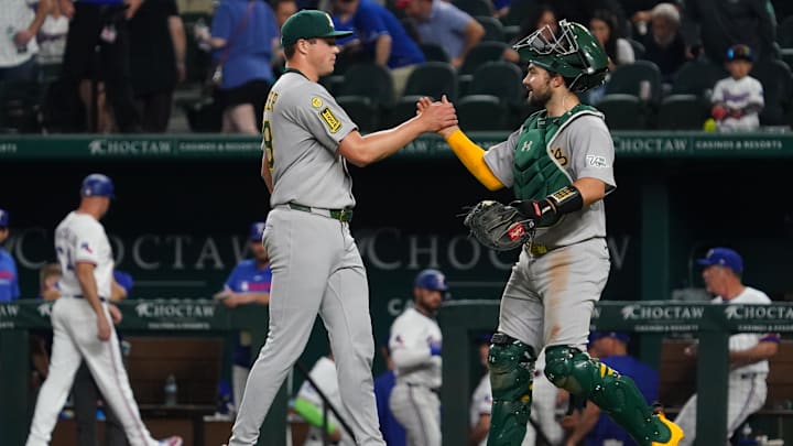 Apr 28, 2025; Arlington, Texas, USA; Athletics pitcher Mason Miller (19) shakes the hand of catcher Shea Langeliers (23) following a game against the Texas Rangers at Globe Life Field. Mandatory Credit: Raymond Carlin III-Imagn Images