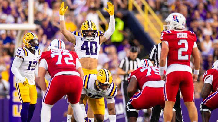 Sep 6, 2025; Baton Rouge, Louisiana, USA;  LSU Tigers linebacker Whit Weeks (40) raises his arms for the fans to make noise against Louisiana Tech Bulldogs quarterback Trey Kukuk (2) during the first half against Louisiana Tech Bulldogs at Tiger Stadium. Mandatory Credit: Stephen Lew-Imagn Images