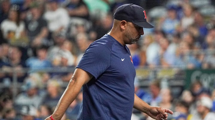 Sep 2, 2023; Kansas City, Missouri, USA; Boston Red Sox manager Alex Cora (13) returns to the dugout
