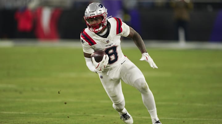 Dec 21, 2025; Baltimore, Maryland, USA;  New England Patriots wide receiver Stefon Diggs (8) runs the ball against the Baltimore Ravens during the second half of the game at M&T Bank Stadium. Mandatory Credit: Mitch Stringer-Imagn Images