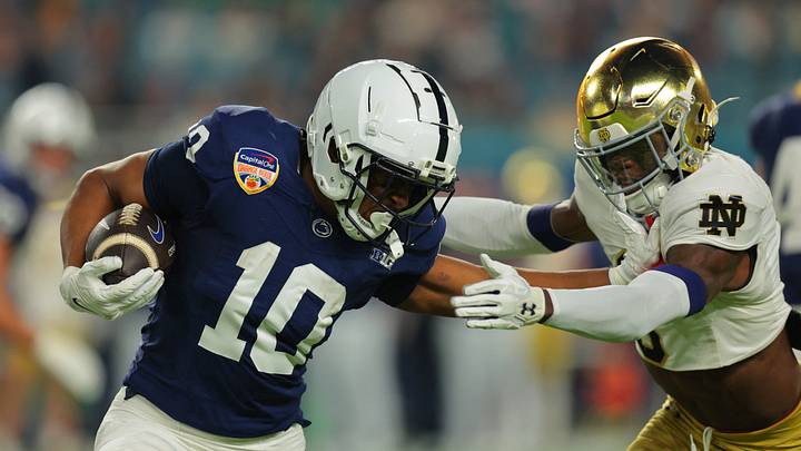 Jan 9, 2025; Miami, FL, USA; Penn State Nittany Lions running back Nicholas Singleton (10) moves the ball defended by Notre Dame Fighting Irish safety Adon Shuler (8) in the first half in the Orange Bowl at Hard Rock Stadium. Mandatory Credit: Sam Navarro-Imagn Images Jan 9, 2025; Miami, FL, USA; Penn State Nittany Lions running back Nicholas Singleton (10) moves the ball defended by Notre Dame Fighting Irish safety Adon Shuler (8) in the first half in the Orange Bowl at Hard Rock Stadium. Mandatory Credit: Sam Navarro-Imagn Images