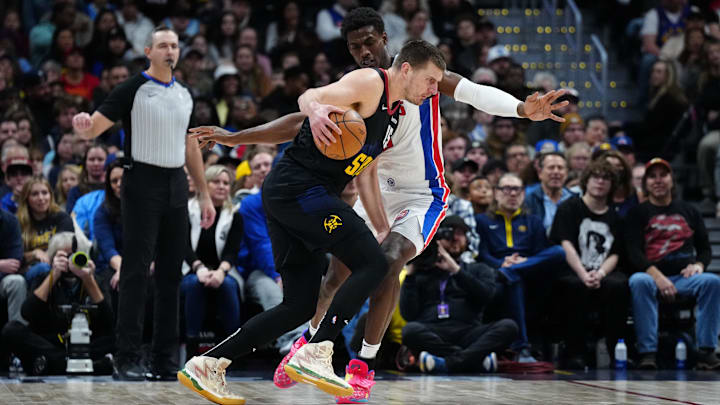 Jan 7, 2024; Denver, Colorado, USA; Denver Nuggets center Nikola Jokic (15) drives at Detroit Pistons center Jalen Duren (0): Ron Chenoy-Imagn Images