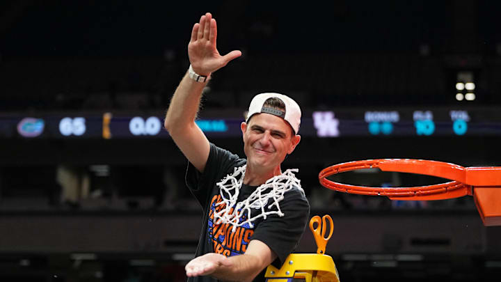 Apr 7, 2025; San Antonio, TX, USA; Florida Gators head coach Todd Golden reacts after cutting down a piece of the net after winning the national championship game of the Final Four of the 2025 NCAA Tournament at the Alamodome. Mandatory Credit: Bob Donnan-Imagn Images