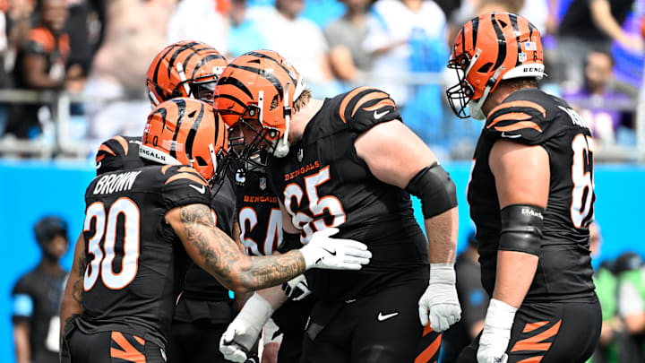 Sep 29, 2024; Charlotte, North Carolina, USA; Cincinnati Bengals running back Chase Brown (30) celebrates with guard Alex Cappa (65) after scoring a touchdown in the first quarter at Bank of America Stadium. Mandatory Credit: Bob Donnan-Imagn Images Sep 29, 2024; Charlotte, North Carolina, USA; Cincinnati Bengals running back Chase Brown (30) celebrates with guard Alex Cappa (65) after scoring a touchdown in the first quarter at Bank of America Stadium. Mandatory Credit: Bob Donnan-Imagn Images