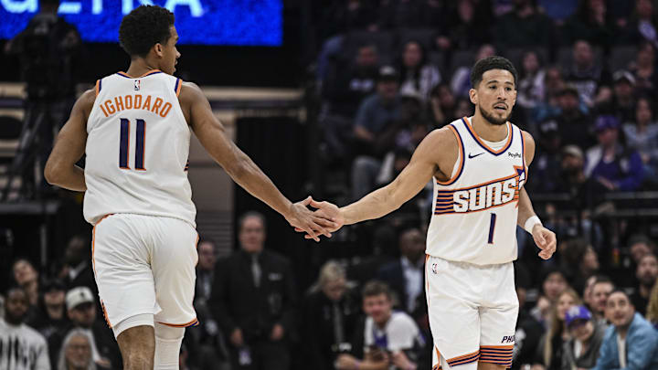 Mar 3, 2026; Sacramento, California, USA; Phoenix Suns forward Oso Ighodaro (11) and Phoenix Suns guard Devin Booker (1) high five during the second quarter against the Sacramento Kings at Golden 1 Center. Mandatory Credit: Justine Willard-Imagn Images