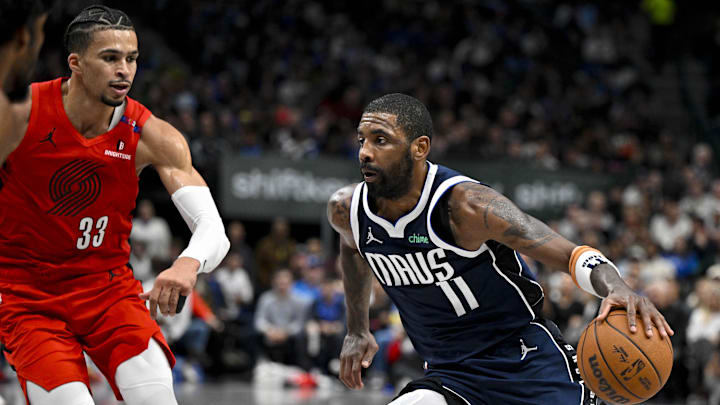 Dec 23, 2024; Dallas, Texas, USA; Dallas Mavericks guard Kyrie Irving (11)  drives to the basket past Portland Trail Blazers forward Toumani Camara (33) during the second half at the American Airlines Center. Mandatory Credit: Jerome Miron-Imagn Images