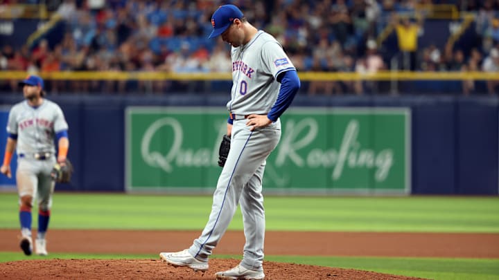 May 4, 2024; St. Petersburg, Florida, USA;  New York Mets pitcher Adam Ottavino (0) looks down after he walked in a run against the Tampa Bay Rays during the eighth inning at Tropicana Field. Mandatory Credit: Kim Klement Neitzel-USA TODAY Sports