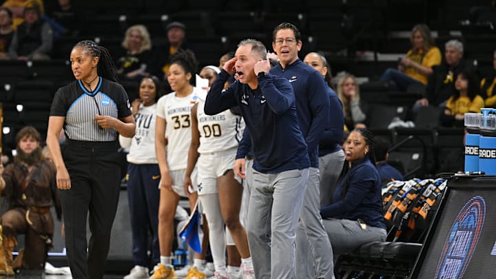Mar 23, 2024; Iowa City, IA, USA; West Virginia Mountaineers head coach Mark Kellogg (middle) reacts during the second half against the Princeton Tigers of the NCAA first round game at Carver-Hawkeye Arena. Mandatory Credit: Jeffrey Becker-Imagn Images Mar 23, 2024; Iowa City, IA, USA; West Virginia Mountaineers head coach Mark Kellogg (middle) reacts during the second half against the Princeton Tigers of the NCAA first round game at Carver-Hawkeye Arena. Mandatory Credit: Jeffrey Becker-Imagn Images
