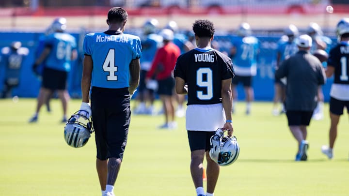 Jul 26, 2025; Charlotte, NC, USA; Carolina Panthers wide receiver Tetairoa McMillan (4) and quarterback Bryce Young (9) talk as they head to stretch during training camp. Mandatory Credit: Scott Kinser-Imagn Images