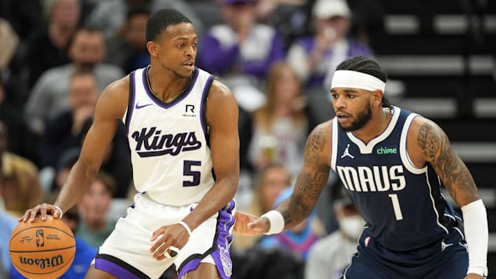 Dec 30, 2024; Sacramento, California, USA; Sacramento Kings guard De'Aaron Fox (5) dribbles against Dallas Mavericks guard Jaden Hardy (1) during the second quarter at Golden 1 Center. Mandatory Credit: Darren Yamashita-Imagn Images