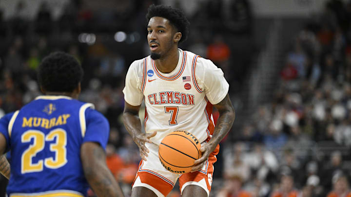 Mar 20, 2025; Providence, RI, USA; Clemson Tigers forward Chauncey Wiggins (7) controls the ball against McNeese State Cowboys guard Brandon Murray (23) during the first half at Amica Mutual Pavilion. Mandatory Credit: Eric Canha-Imagn Images