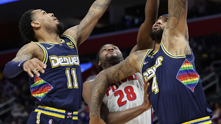 Jan 25, 2022; Detroit, Michigan, USA;  Denver Nuggets guard Monte Morris (11) Detroit Pistons center Isaiah Stewart (28) and center DeMarcus Cousins (4) goes for the rebound in the second half at Little Caesars Arena. Mandatory Credit: Rick Osentoski-Imagn Images
