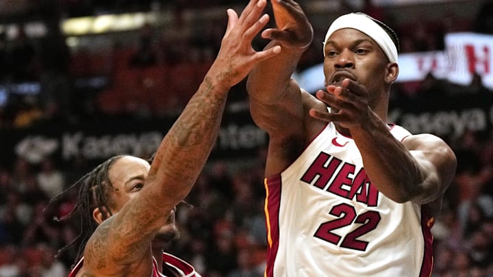 Dec 14, 2023; Miami, Florida, USA; Miami Heat forward Jimmy Butler (22) passes the ball as Chicago Bulls forward DeMar DeRozan (11) defends during the second half at Kaseya Center. Mandatory Credit: Jim Rassol-Imagn Images