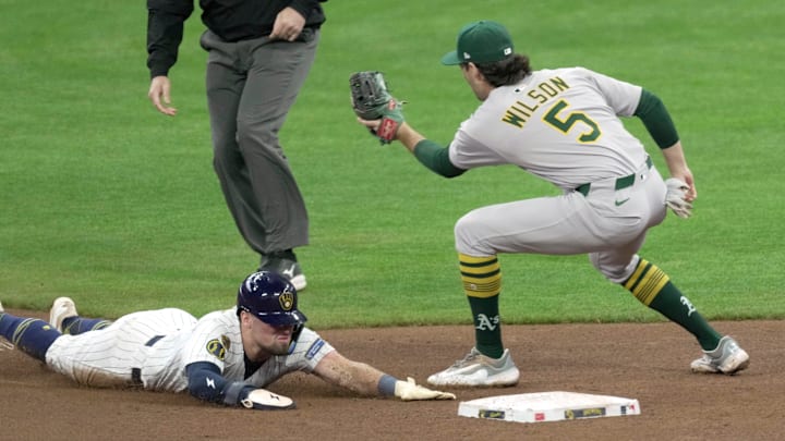 Milwaukee Brewers' Caleb Durbin (21) beats the throw to Oakland Athletics shortstop Jacob Wilson (5) to steal second base during the fourth inning of their game Sunday, April 20, 2025 at American Family Field in Milwaukee, Wisconsin.