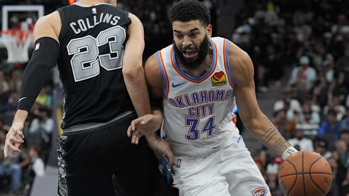 Nov 19, 2024; San Antonio, Texas, USA;  Oklahoma City Thunder forward Kenrich Williams (34) drives against around San Antonio Spurs forward Zach Collins (23) in the second half at Frost Bank Center. Mandatory Credit: Daniel Dunn-Imagn Images