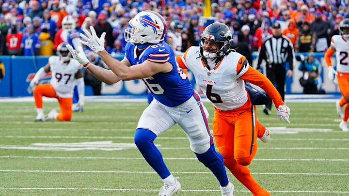 Buffalo Bills tight end Dalton Kincaid (86) puts his hands up and catches successfully the pass while Denver Broncos safety P.J. Locke (6) keeps pace with him during the second half of the Buffalo Bills wild card game against the Denver Broncos at Highmark Stadium in Orchard Park on Jan. 12, 2025.