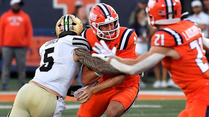 Purdue Boilermakers linebacker Charles Correa (5) sacks Illinois Fighting Illini quarterback Katin Houser (4). Purdue Boilermakers linebacker Charles Correa (5) sacks Illinois Fighting Illini quarterback Katin Houser (4).