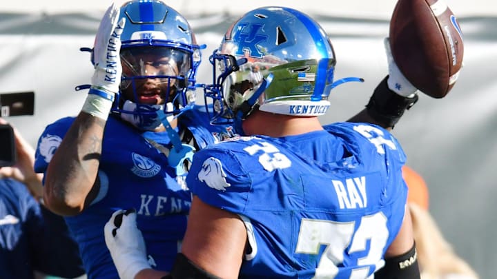 Kentucky Wildcats running back Ray Davis (1) celebrates with teammate offensive lineman Dylan Ray (73) after his touchdown to give Kentucky a 30 to 34 lead with under three minutes to play in the game. The Kentucky Wildcats faced off against the Clemson Tigers Friday, December 29, 2023, in the TaxSlayer Gator Bowl in Jacksonville, Florida. The Wildcats led 14 to 10 at the half but the Tigers fought back and came away with a 38 to 35 victory. [Bob Self/Florida Times-Union]