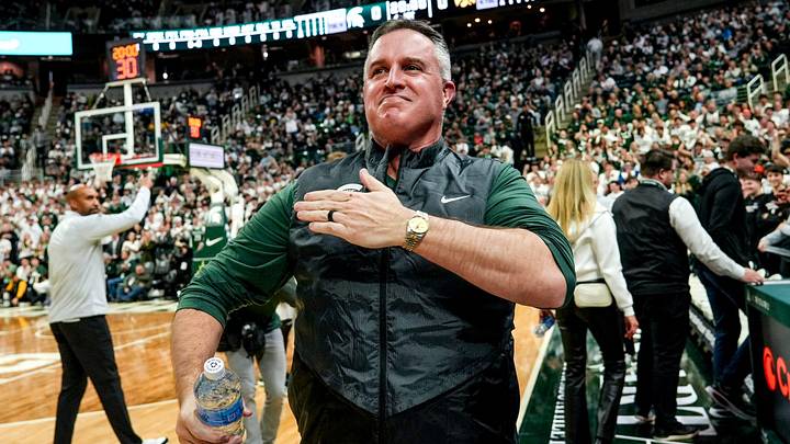 Michigan State's new football coach Pat Fitzgerald pats his heart at the crowd in attendance for the Spartans basketball game against Iowa on Tuesday, Dec. 2, 2025, at the Breslin Center in East Lansing. Michigan State's new football coach Pat Fitzgerald pats his heart at the crowd in attendance for the Spartans basketball game against Iowa on Tuesday, Dec. 2, 2025, at the Breslin Center in East Lansing.