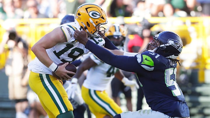 Seattle Seahawks linebacker Jared Ivey (51) tries to tackle Green Bay Packers quarterback Taylor Elgersma (19) during a preseason game on Aug. 23, 2025, at Lambeau Field in Green Bay, Wis. Seattle Seahawks linebacker Jared Ivey (51) tries to tackle Green Bay Packers quarterback Taylor Elgersma (19) during a preseason game on Aug. 23, 2025, at Lambeau Field in Green Bay, Wis.