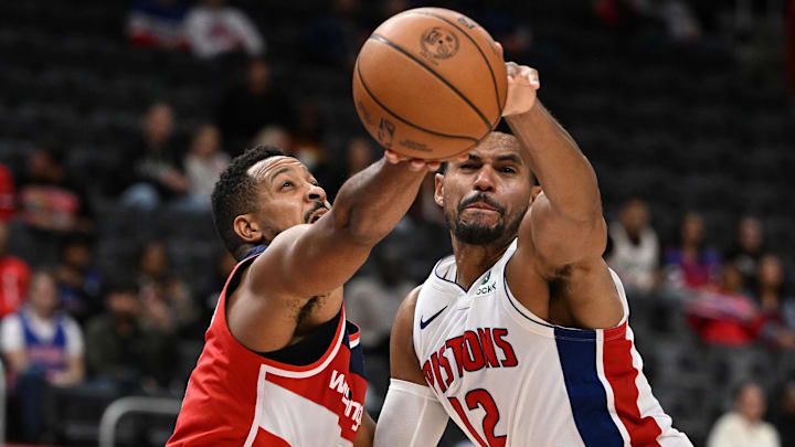 Oct 16, 2025; Detroit, Michigan, USA; Detroit Pistons forward Tobias Harris (12) blocks a shot from Washington Wizards guard CJ McCollum (3) in the second quarter at Little Caesars Arena. Mandatory Credit: Lon Horwedel-Imagn Images