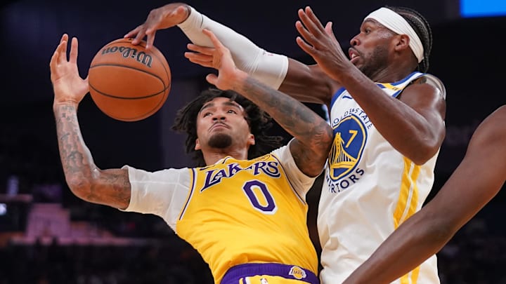 Oct 18, 2024; San Francisco, California, USA; Golden State Warriors guard Buddy Hield (7) knocks the ball out of the hands of Los Angeles Lakers guard Jalen Hood-Schifino (0) in the first quarter at the Chase Center. Mandatory Credit: Cary Edmondson-Imagn Images
