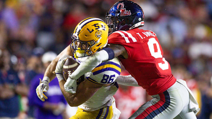 Oct 12, 2024; Baton Rouge, Louisiana, USA;  LSU Tigers tight end Mason Taylor (86) makes a first down against Mississippi Rebels cornerback Trey Amos (9) during the second half at Tiger Stadium. Mandatory Credit: Stephen Lew-Imagn Images