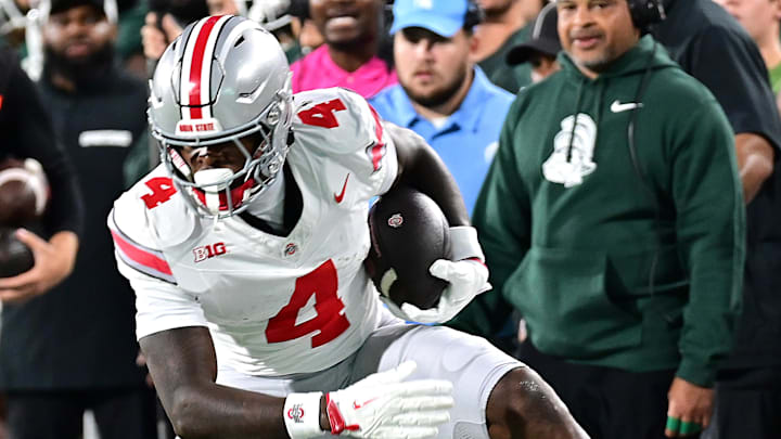 Sep 28, 2024; East Lansing, Michigan, USA; Michigan State Spartans defensive back Ed Woods (4) can’t reach Ohio State Buckeyes wide receiver Jeremiah Smith (4) in the first quarter at Spartan Stadium. Sep 28, 2024; East Lansing, Michigan, USA; Michigan State Spartans defensive back Ed Woods (4) can’t reach Ohio State Buckeyes wide receiver Jeremiah Smith (4) in the first quarter at Spartan Stadium.