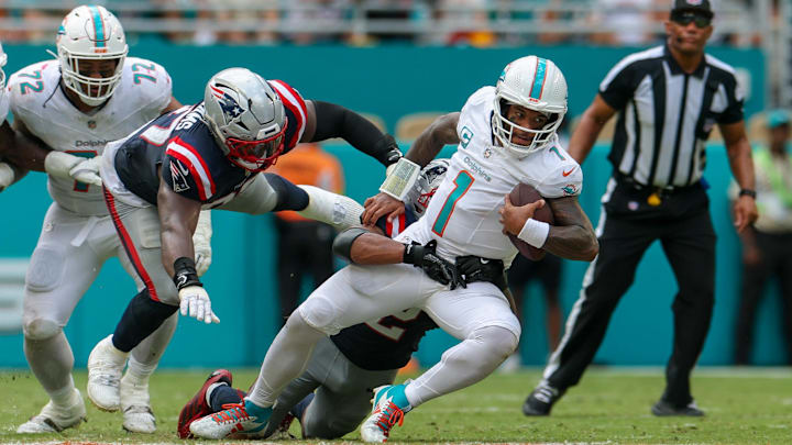Miami Dolphins quarterback Tua Tagovailoa (1) is tailed by New England Patriots linebacker Harold Landry III (2) in the fourth quarter at Hard Rock Stadium. Miami Dolphins quarterback Tua Tagovailoa (1) is tailed by New England Patriots linebacker Harold Landry III (2) in the fourth quarter at Hard Rock Stadium.