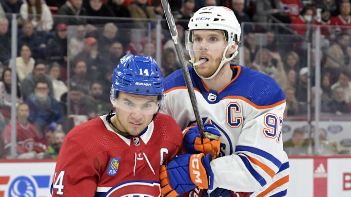 Montreal Canadiens forward Nick Suzuki (14) and Edmonton Oilers Connor McDavid (97)