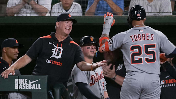 Detroit Tigers manager A.J. Hinch (14) high fives second baseman Gleyber Torres (25) after he hit a home run against the Athletics during the sixth inning at Sutter Health Park.