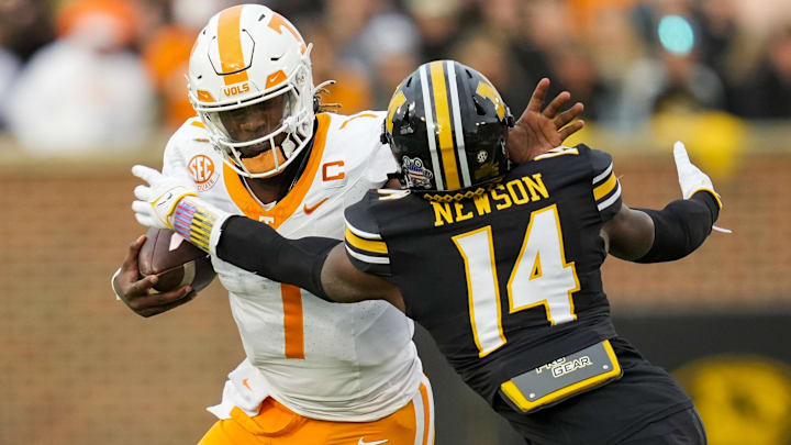 Nov 11, 2023; Columbia, Missouri, USA; Tennessee Volunteers quarterback Joe Milton III (7) stiff arms Missouri Tigers linebacker Triston Newson (14) during the first half at Faurot Field at Memorial Stadium. Mandatory Credit: Jay Biggerstaff-Imagn Images Nov 11, 2023; Columbia, Missouri, USA; Tennessee Volunteers quarterback Joe Milton III (7) stiff arms Missouri Tigers linebacker Triston Newson (14) during the first half at Faurot Field at Memorial Stadium. Mandatory Credit: Jay Biggerstaff-Imagn Images