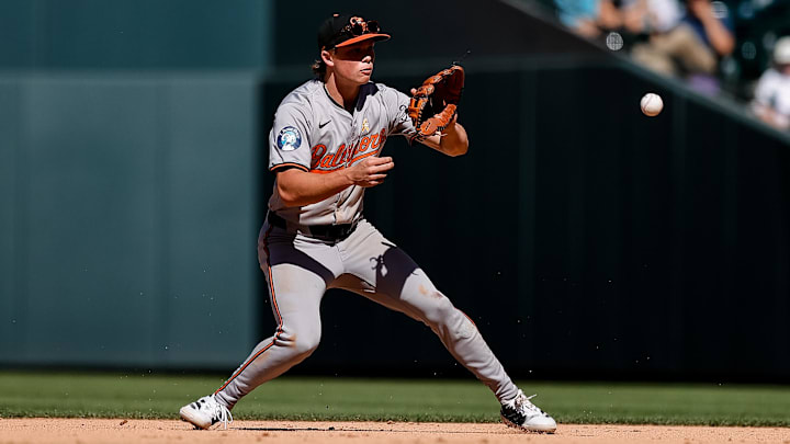 Sep 1, 2024; Denver, Colorado, USA; Baltimore Orioles second baseman Jackson Holliday (7) fields the ball in the ninth inning against the Colorado Rockies at Coors Field.