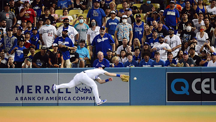 Jul 22, 2021; Los Angeles, California, USA; Los Angeles Dodgers right fielder Billy McKinney (29) makes a play for the triple hit by San Francisco Giants right fielder Mike Yastrzemski (5) during the sixth inning at Dodger Stadium. Mandatory Credit: Gary A. Vasquez-Imagn Images