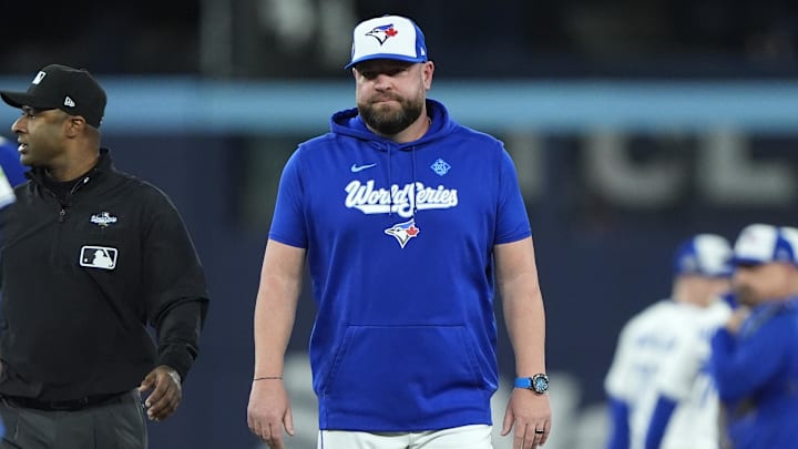 Blue Jays manager John Schneider is walking off the field after the benches cleared in Game 7 of the World Series